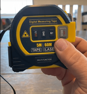 Customer holding the SuperBox 3-in-1 tape measure